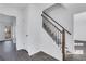 Bright hallway featuring updated staircase with modern wood and wrought iron banister and gray wood flooring at 2250 Deer Oaks Trl, Lawrenceville, GA 30044
