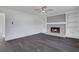 Bright living room features a fireplace, built-in shelves, modern ceiling fan, and sleek flooring at 2250 Deer Oaks Trl, Lawrenceville, GA 30044