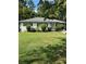 Charming single-story house with white exterior and lush green front yard at 3042 Santa Monica Dr, Decatur, GA 30032