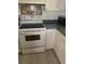 Kitchen featuring a white range oven, laminated countertop and white cabinets at 3042 Santa Monica Dr, Decatur, GA 30032