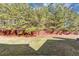 View of backyard featuring a wood fence, grass, and mature trees at 6462 Splitpine Ct, Atlanta, GA 30349