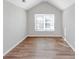 Bright bedroom with hardwood floors, a window, and vaulted ceilings at 6462 Splitpine Ct, Atlanta, GA 30349