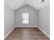 Bedroom with wood flooring and a single window, creating a serene and restful environment at 6462 Splitpine Ct, Atlanta, GA 30349