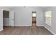 Bright bedroom with hardwood floors and access to a bath and closet at 6462 Splitpine Ct, Atlanta, GA 30349