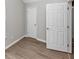 Bedroom featuring neutral walls, hardwood floors, and a white door at 6462 Splitpine Ct, Atlanta, GA 30349