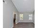 Bedroom with neutral walls, hardwood floors, and access to other spaces at 6462 Splitpine Ct, Atlanta, GA 30349