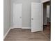 Bedroom showcasing neutral walls, hardwood floors, and doors to other spaces at 6462 Splitpine Ct, Atlanta, GA 30349