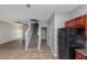 Open kitchen and living room layout with stairwell, refrigerator and tile flooring at 6462 Splitpine Ct, Atlanta, GA 30349