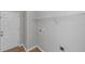 Neutral laundry room featuring a door to the outside with overhead shelving and hookups ready for appliances at 6462 Splitpine Ct, Atlanta, GA 30349