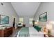 Stylish main bedroom features art, lamps, chair, a bed with green accents at 6462 Splitpine Ct, Atlanta, GA 30349