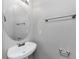 Powder room featuring pedestal sink and round mirror, offering a clean and minimalist design at 6462 Splitpine Ct, Atlanta, GA 30349