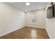 Bedroom featuring hardwood floors, a window, a ceiling light, and a modern ceiling fan at 3560 Pleasant Grove Rd, Cumming, GA 30028