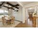 Dining room featuring rustic wood beams, stylish chandelier, and view of the front entryway at 3560 Pleasant Grove Rd, Cumming, GA 30028