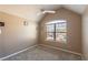 Bright bedroom featuring a vaulted ceiling and large window with neighborhood views at 5809 Savannah River, Atlanta, GA 30349