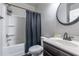 Functional bathroom with shower and tub combination, single sink vanity, and modern fixtures at 5809 Savannah River, Atlanta, GA 30349