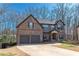 Attractive two-story brick and stone home with a two-car garage and well-maintained front yard at 5809 Savannah River, Atlanta, GA 30349