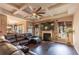 Cozy living room with fireplace, hardwood floors, ceiling fan, and a leather sofa at 5809 Savannah River, Atlanta, GA 30349