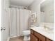 Bright bathroom with a single sink vanity, modern fixtures, and a shower with a curtain at 149 Manor Lane, Woodstock, GA 30188