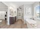 Bright bathroom with double vanity, soaking tub, and doorway access to another room at 149 Manor Lane, Woodstock, GA 30188