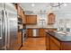 Kitchen showcasing stainless steel appliances, wooden cabinetry, and granite countertops at 149 Manor Lane, Woodstock, GA 30188