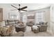 Relaxing living room with a spacious sectional, contemporary ceiling fan, and ample natural light at 149 Manor Lane, Woodstock, GA 30188