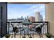 Balcony with wrought iron table and seating overlooking the city skyline at 3481 Lakeside Ne Dr # 2207, Atlanta, GA 30326