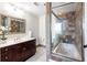 Bathroom with tiled shower and tub combination and dark wooden vanity with white countertop at 3481 Lakeside Ne Dr # 2207, Atlanta, GA 30326