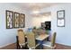 Dining room with wicker chairs, a modern chandelier, and an open view into the kitchen at 3481 Lakeside Ne Dr # 2207, Atlanta, GA 30326