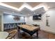 Well-lit game room with a pool table, tv and bar seating against an accent wall at 3481 Lakeside Ne Dr # 2207, Atlanta, GA 30326