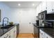 Kitchen featuring black granite countertops and a double sink at 3481 Lakeside Ne Dr # 2207, Atlanta, GA 30326