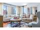 Bright living room featuring large windows with city views, hardwood floors, and stylish furniture at 3481 Lakeside Ne Dr # 2207, Atlanta, GA 30326