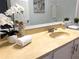 Bathroom featuring vanity with granite countertop, decorative mirror, and modern fixtures at 904 Wentworth Ct, Alpharetta, GA 30022