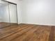 Spacious empty bedroom offering laminate flooring and a large mirrored closet at 904 Wentworth Ct, Alpharetta, GA 30022