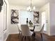 Dining area features modern chandelier, glass table, and chic artwork for a stylish meal setting at 904 Wentworth Ct, Alpharetta, GA 30022