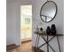 Inviting entryway with a decorative table, round mirror, and a view into the bright, updated bathroom at 904 Wentworth Ct, Alpharetta, GA 30022