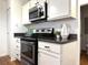 Modern kitchen with stainless steel appliances, white cabinetry, and granite countertops at 904 Wentworth Ct, Alpharetta, GA 30022