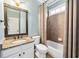 Cozy bathroom featuring granite countertop vanity, toilet and shower with patterned curtains at 2460 Millwater Crossing Xing, Dacula, GA 30019