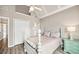 Bedroom featuring hardwood floors, ceiling fan, and double door closet at 2460 Millwater Crossing Xing, Dacula, GA 30019