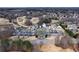 Aerial view of clubhouse and parking lot within a golf course community, offering premier amenities and convenience at 2460 Millwater Crossing Xing, Dacula, GA 30019