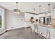 Kitchen featuring granite countertops, white cabinets, stainless steel appliances and pendant lighting at 2460 Millwater Crossing Xing, Dacula, GA 30019