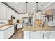 Bright kitchen featuring white cabinets, stainless appliances, granite countertops, and a breakfast bar at 2460 Millwater Crossing Xing, Dacula, GA 30019