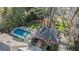 Aerial shot showcases a private pool and sprawling property with mature trees at 3000 Rivermeade Nw Dr, Atlanta, GA 30327