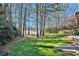 Beautiful backyard featuring lush green grass and picturesque lake views at 3000 Rivermeade Nw Dr, Atlanta, GA 30327