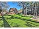 Expansive backyard with lush lawn leading up to a stately brick home at 3000 Rivermeade Nw Dr, Atlanta, GA 30327