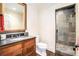 This full bathroom includes wood vanity with a granite countertop and a tiled standing shower at 3000 Rivermeade Nw Dr, Atlanta, GA 30327