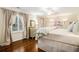 This primary bedroom features hardwood floors, plantation shutters, and light neutral colors at 3000 Rivermeade Nw Dr, Atlanta, GA 30327