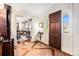 Inviting foyer showcasing brick flooring, a wooden front door, and views into the dining room at 3000 Rivermeade Nw Dr, Atlanta, GA 30327