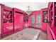 Bright pink office features custom built-ins, hardwood floors, and stylish light fixture at 3000 Rivermeade Nw Dr, Atlanta, GA 30327