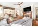 Inviting living room featuring a fireplace, hardwood floors, and an open layout leading to the kitchen at 3000 Rivermeade Nw Dr, Atlanta, GA 30327