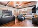 Unique living room with wood-paneled ceiling, media center, hardwood floors, and a comfortable recliner at 3000 Rivermeade Nw Dr, Atlanta, GA 30327